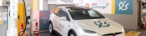 An electric vehicle (EV) charging at Shell Recharge site