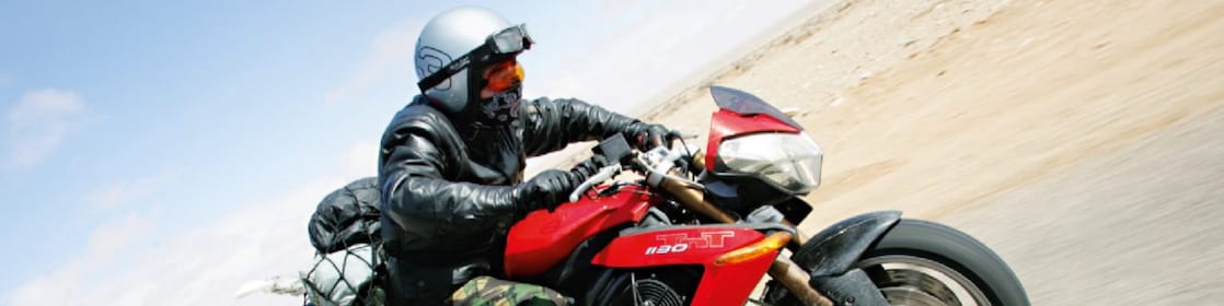 Gary Inman riding a motorbike through the dessert