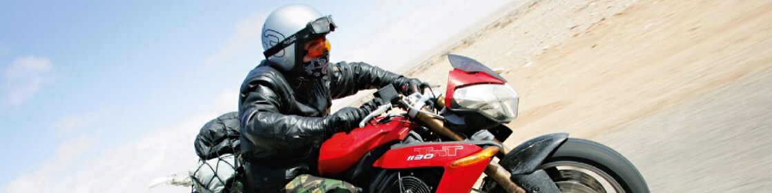 Gary Inman riding a motorbike through the dessert