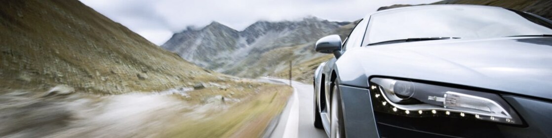 car driving along a winding mountain road