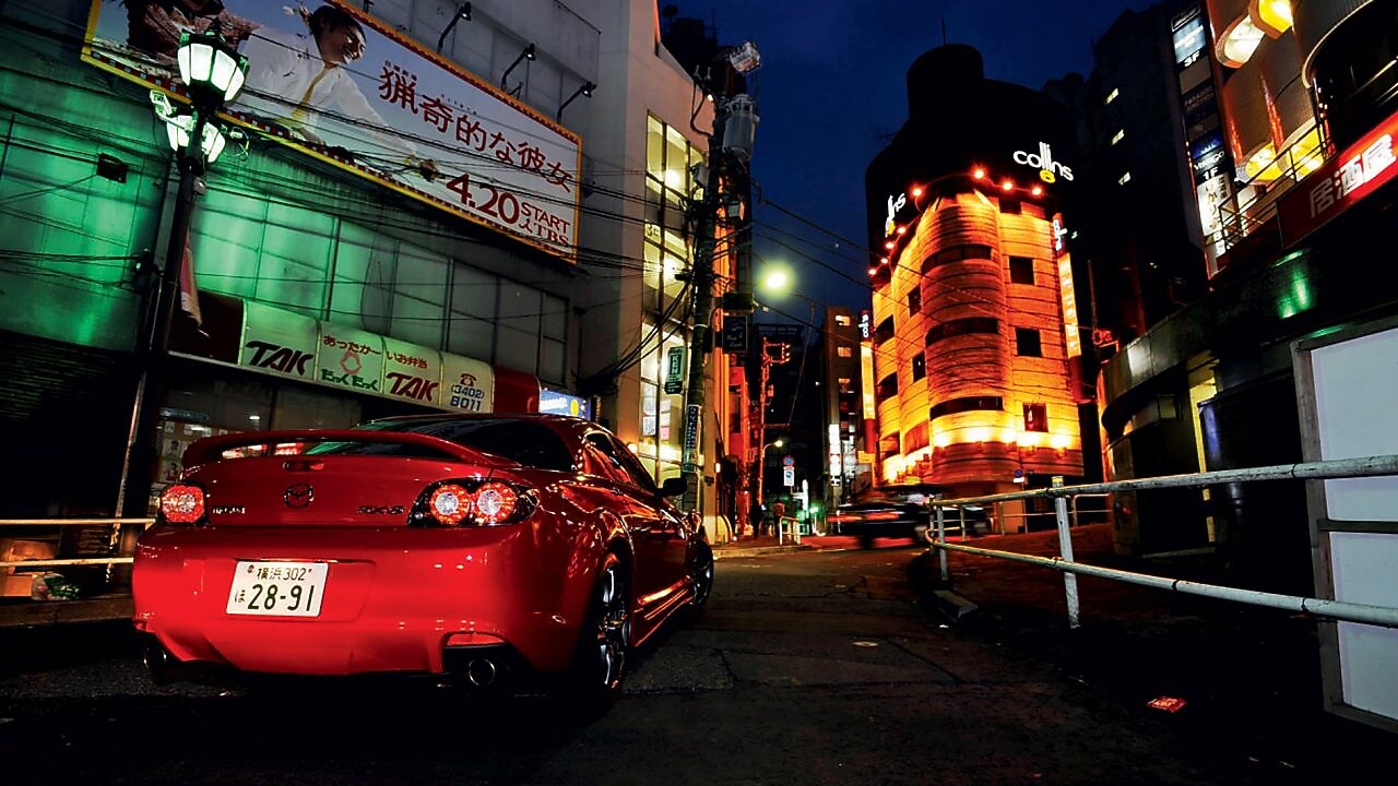 Mazda driving at night through Tokyo