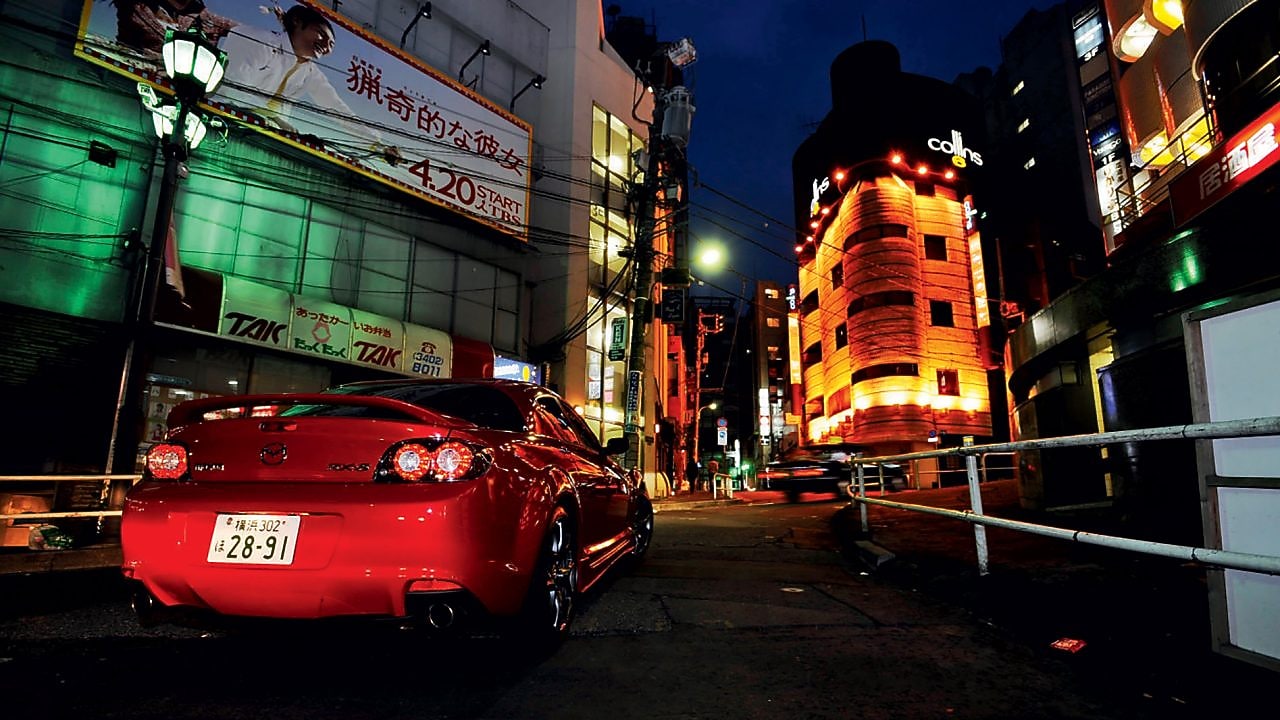 Mazda driving at night through Tokyo