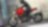 A man driving a motorcycle using extraordinary engine oil.