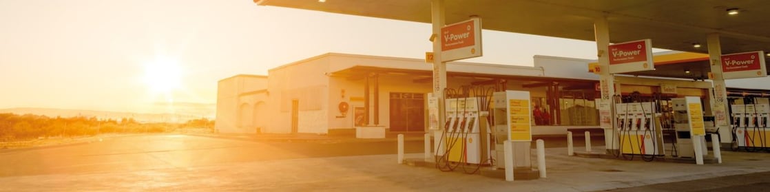 The forecourt of a shell service station at dusk