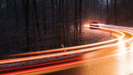 Red car on the bridge with family sitting in it