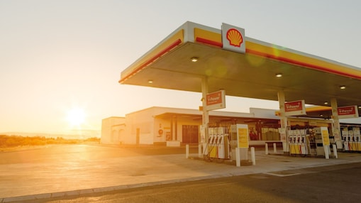 Sun rising behind a Shell station forecourt
