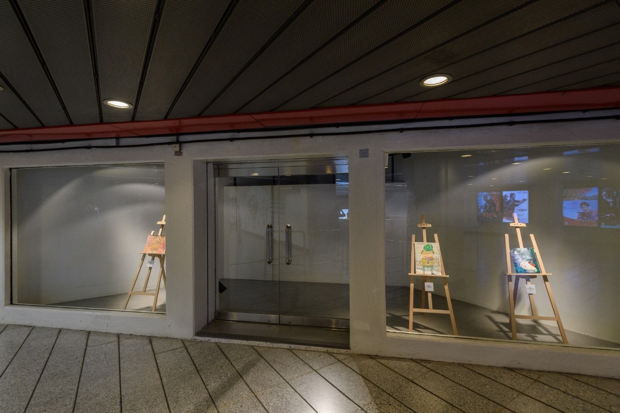 Painting on stand in glass room art exhibition