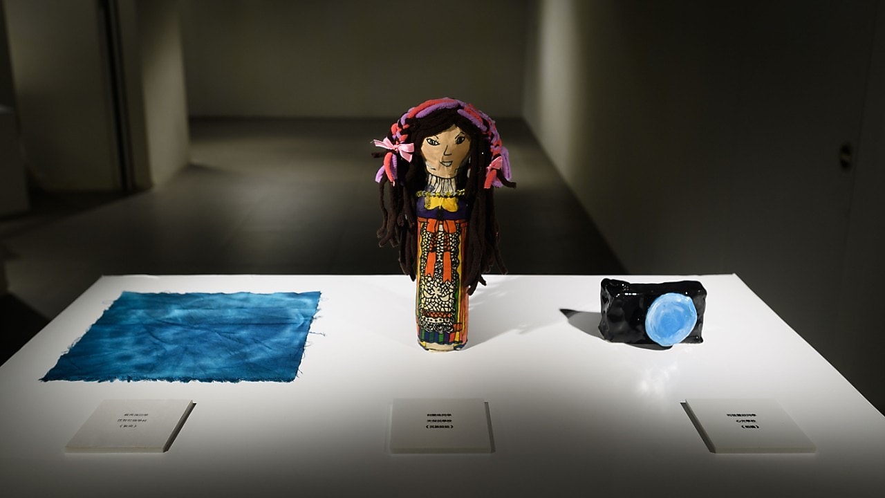 Doll and camera on white table