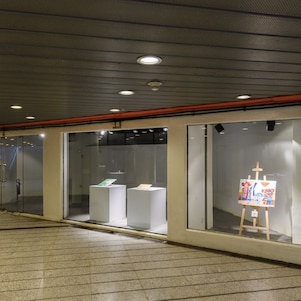 Painting in glass room at art exhibition