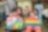 Students with special educational needs and teacher took photo with their paintings.