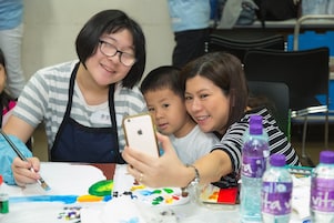 Student with special educational needs, teacher and parent had selfie together during the workshop.