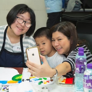 Student with special educational needs, teacher and parent had selfie together during the workshop.