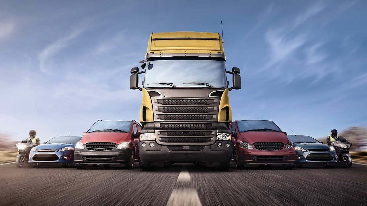 Cars and trucks in line on the road