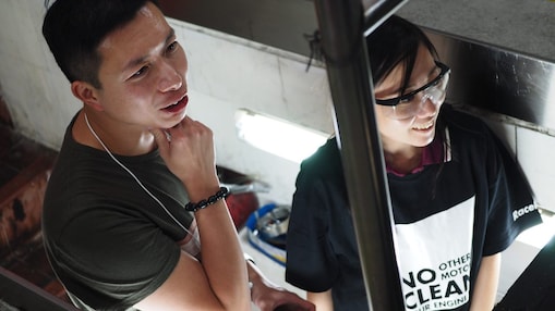 two people standing and listening